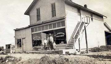 [Photo: Ralph, Grandpa Painter and
Dorothy, in front of the Barclay General Store.]