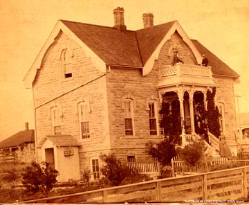 [The Mueller-Schmidt House, Emelia Mueller's
wedding day, June 12, 1889.  John Mueller and son Henry on balcony; Emelia
on lower step, Karoline Mueller and groom John Chambliss, on porch.  All
rights reserved, Ford County Historical Society, Dodge City,
KS.]