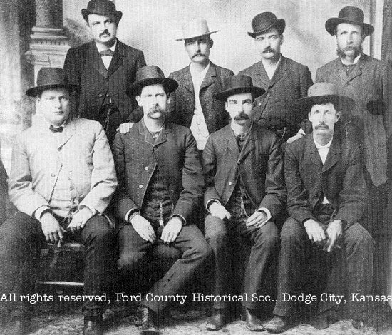 [Photo: Original photograph of the 'Dodge City Peace Commission' in
June, 1883. Front, l-r; Chas. E. Bassett, Wyatt S. Earp, Frank McLain, and
Neil Brown. Back, l-r; W. H. Harris, Luke Short, W. B. Bat Masterson, and
W. F. Petillon. This is the version with Petillon beside Masterson. Used with permission. All
rights reserved. FCHS.]